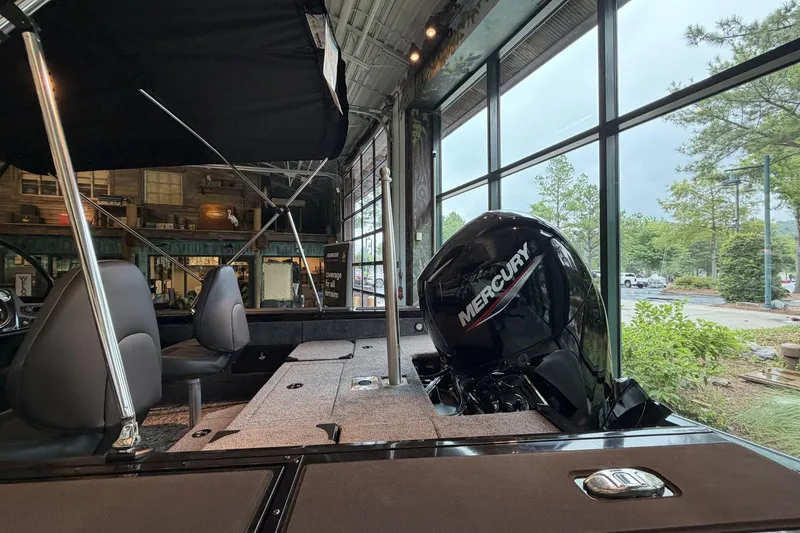Slide: The Image of 2026 Tracker Targa V-18 Combo boat interior with Mercury engine, showroom display. - 5