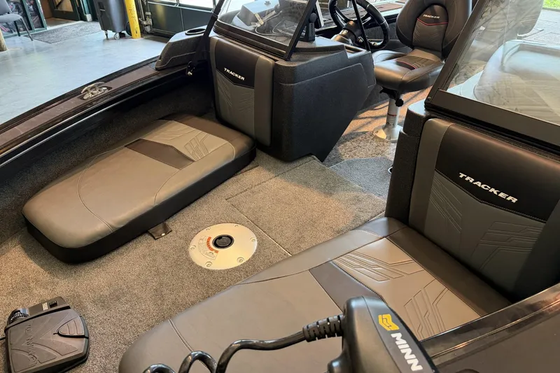 Slide: The Image of 2026 Tracker Targa V-18 Combo boat interior with seating and steering console. - 3
