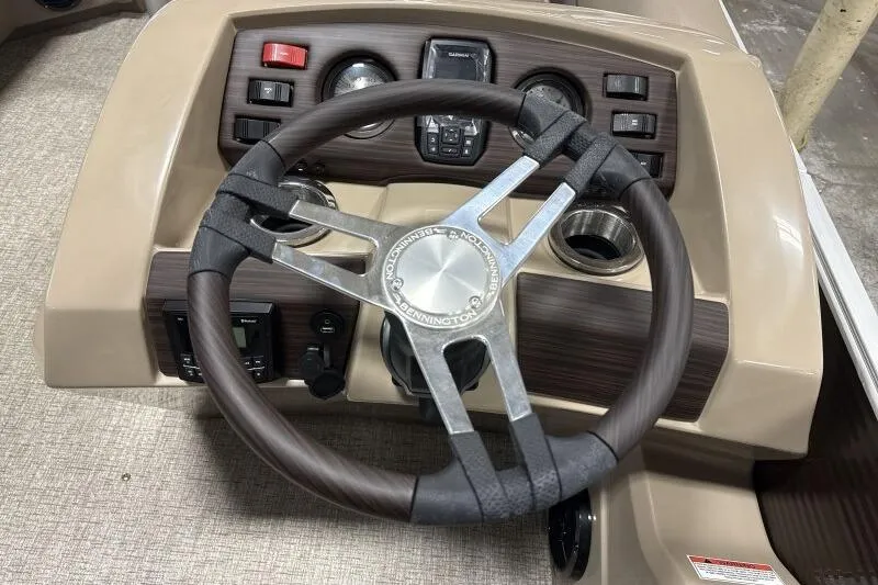 Slide: The Image of Steering wheel and dashboard of 2026 Bennington 22SXSR boat, featuring modern controls. - 12