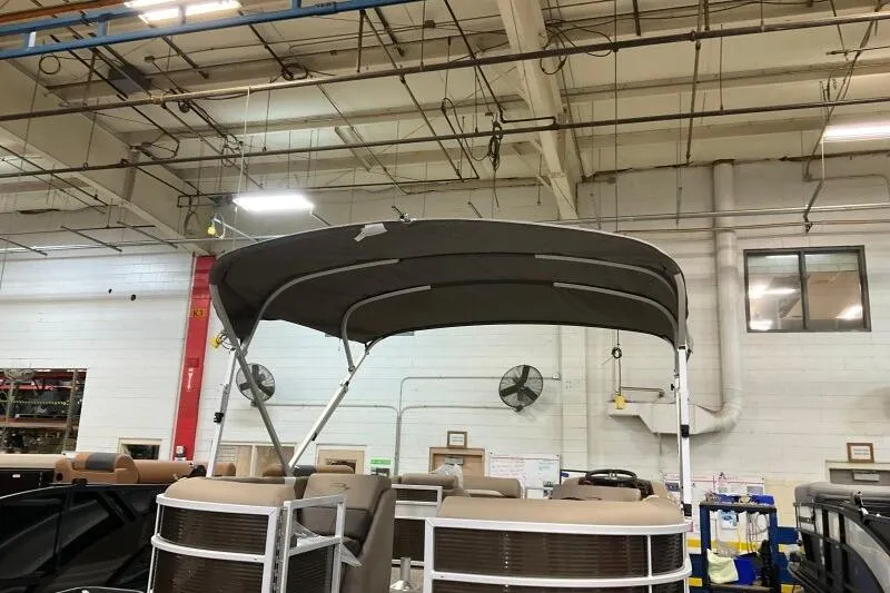 Slide: The Image of 2026 Bennington 22SXSR pontoon boat with canopy in a factory setting. - 13