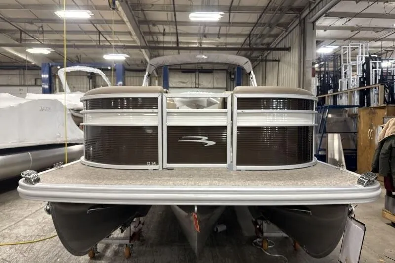 Slide: The Image of 2026 Bennington 22SXSR pontoon boat in a warehouse setting. - 4