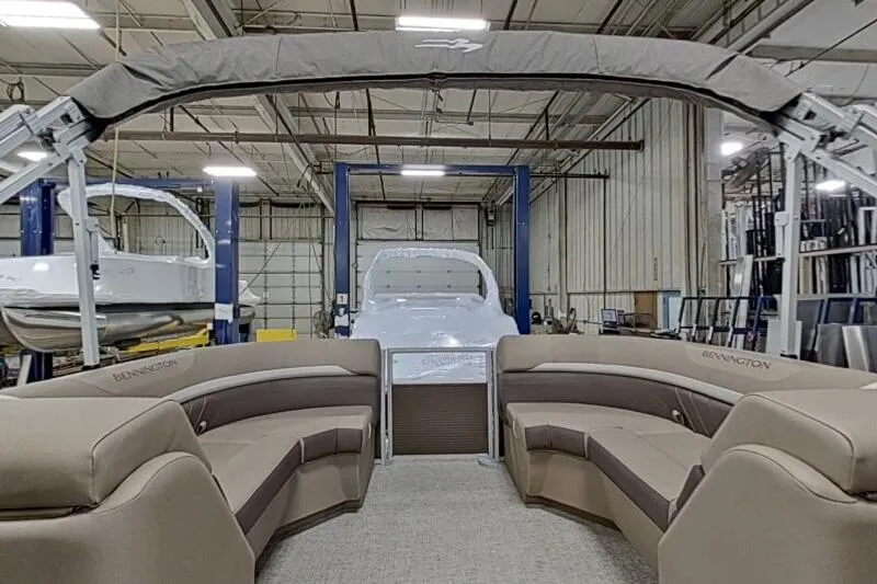 Slide: The Image of 2026 Bennington 22SXSR pontoon boat interior in a warehouse setting. - 5