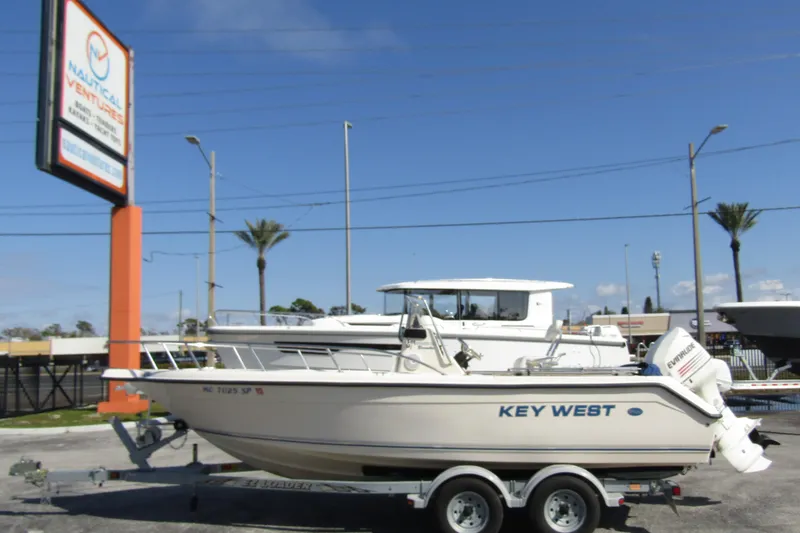 The Image of Key West 2020 Center Console boat on trailer at dealership, clear sky background. - 0