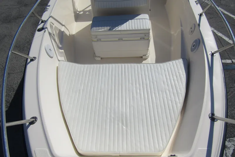 Slide: The Image of 2004 Key West Center Console boat interior with cushioned seating and storage. - 10