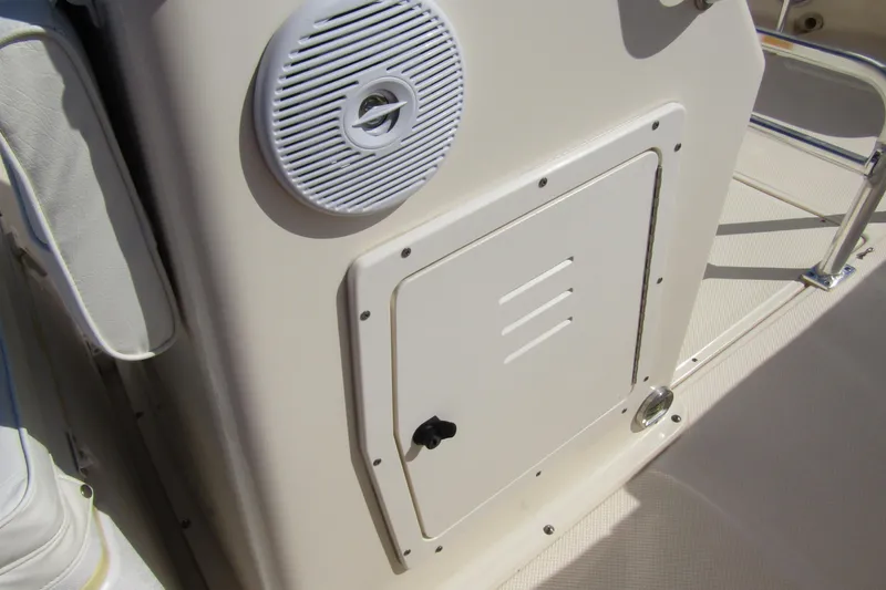 Slide: The Image of Key West 2020 Center Console boat interior, featuring speaker and storage compartment. - 13