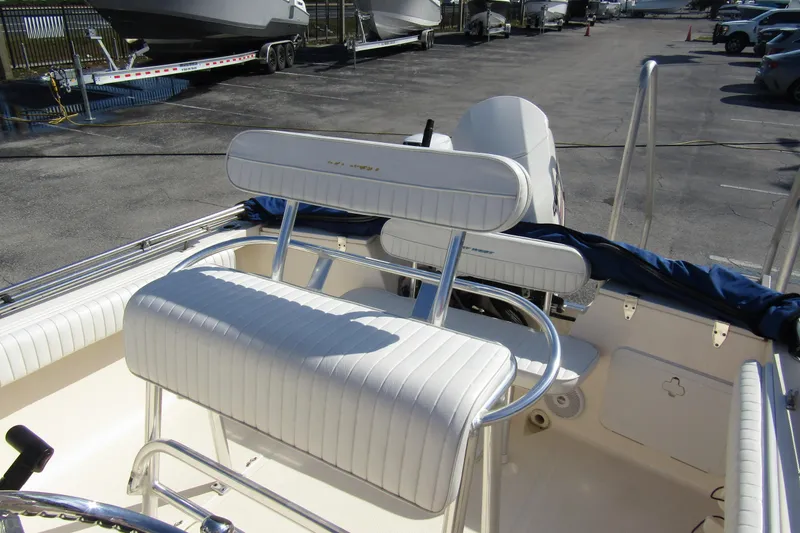 Slide: The Image of 2004 Key West Center Console boat interior with white seating and steering wheel. - 15