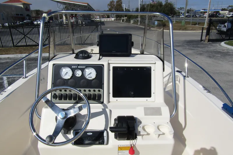 Slide: The Image of Key West 2020 Center Console boat dashboard with steering wheel and gauges, 2004 model. - 16