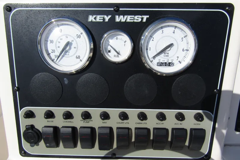 Slide: The Image of Control panel of a 2004 Key West 2020 Center Console boat with gauges and switches. - 18