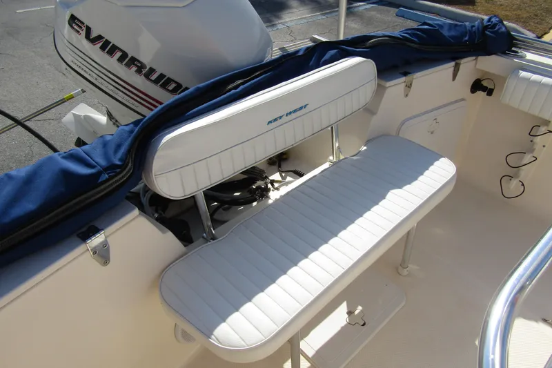 Slide: The Image of White seating on a 2004 Key West 2020 Center Console boat with Evinrude engine. - 22