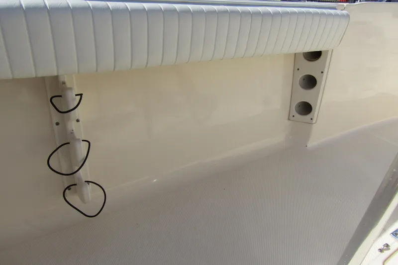 Slide: The Image of Interior of 2004 Key West Center Console boat with rod holders and cushioned seating. - 23