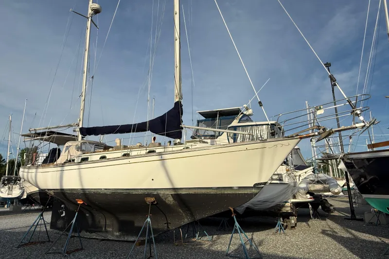 The Image of 1978 Shannon 38 sailboat on stands in a boatyard under clear skies. - 0