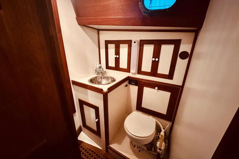 Slide: The Image of 1978 Shannon 38 yacht bathroom with wooden cabinetry and stainless steel sink. - 13