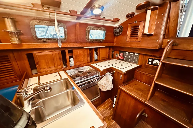 Slide: The Image of Vintage 1978 Shannon 38 yacht interior with wooden cabinetry and kitchen amenities. - 14