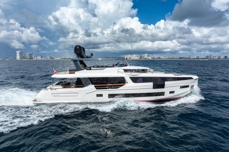 Slide: The Image of Luxurious 2021 Sirena 88 yacht cruising on open water under a cloudy sky. - 1