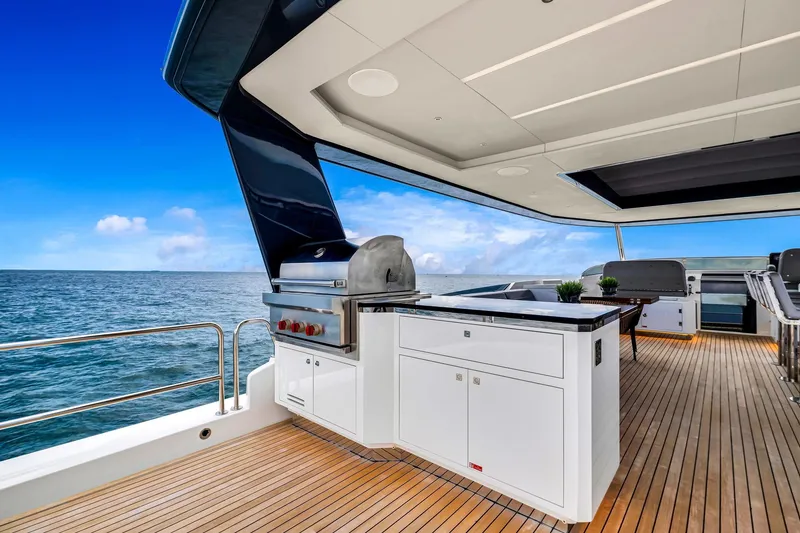 Slide: The Image of Luxurious 2021 Sirena 88 yacht deck with modern outdoor kitchen and ocean view. - 13