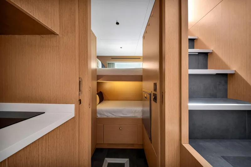 Slide: The Image of Luxurious interior of 2021 Sirena 88 yacht featuring modern wood finishes and cozy sleeping area. - 136