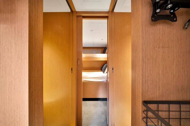 Slide: The Image of Interior of 2021 Sirena 88 yacht, featuring a cozy wooden cabin with bunk beds. - 138
