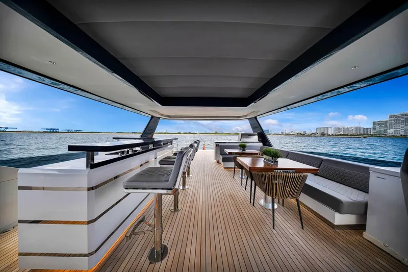 Slide: The Image of Luxurious 2021 Sirena 88 yacht interior with sleek bar, dining area, and ocean view. - 19