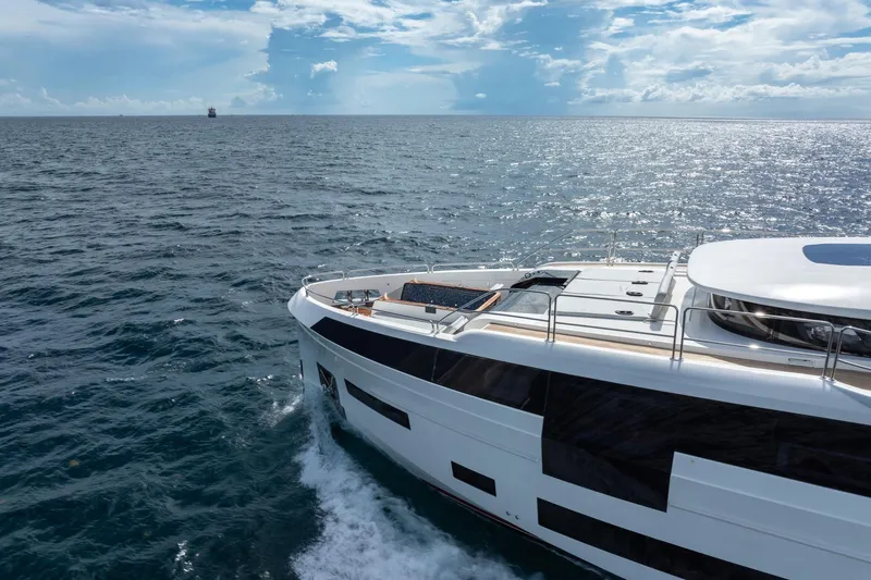 Slide: The Image of Luxury Sirena 88 yacht cruising on open sea under a bright sky, 2021 model. - 27