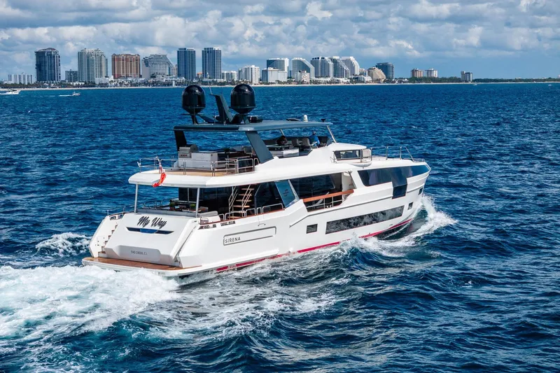 Slide: The Image of Luxurious 2021 Sirena 88 yacht cruising near a city skyline on a sunny day. - 3