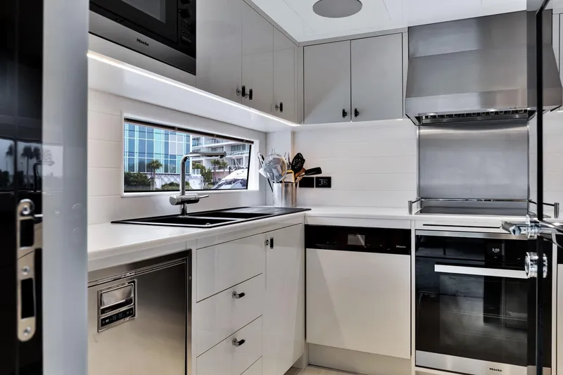 Slide: The Image of Modern kitchen interior on Sirena 88 yacht, featuring sleek appliances and minimalist design, 2021 model. - 63