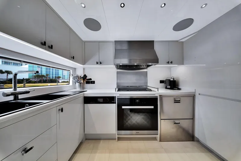 Slide: The Image of Modern kitchen interior on 2021 Sirena 88 yacht, featuring sleek cabinetry and stainless steel appliances. - 64