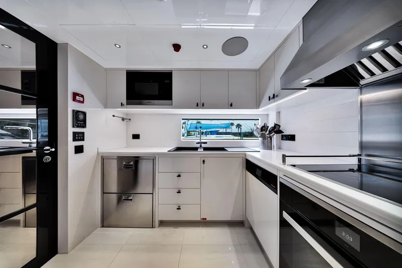 Slide: The Image of Modern kitchen interior on 2021 Sirena 88 yacht, featuring sleek appliances and minimalist design. - 66