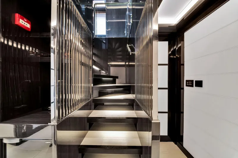 Slide: The Image of Modern interior staircase on 2021 Sirena 88 yacht, featuring sleek design and metallic accents. - 96