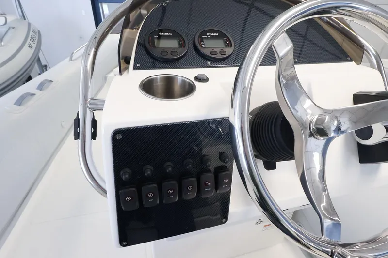 Slide: The Image of 2022 AB Inflatables Oceanus 17 VST boat dashboard with steering wheel and controls. - 11