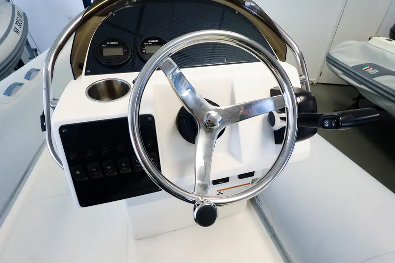 Slide: The Image of 2022 AB Inflatables Oceanus 17 VST boat steering console with controls and gauges. - 12