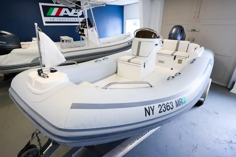 Slide: The Image of 2022 AB Inflatables Oceanus 17 VST boat displayed indoors, featuring sleek design and modern features. - 2