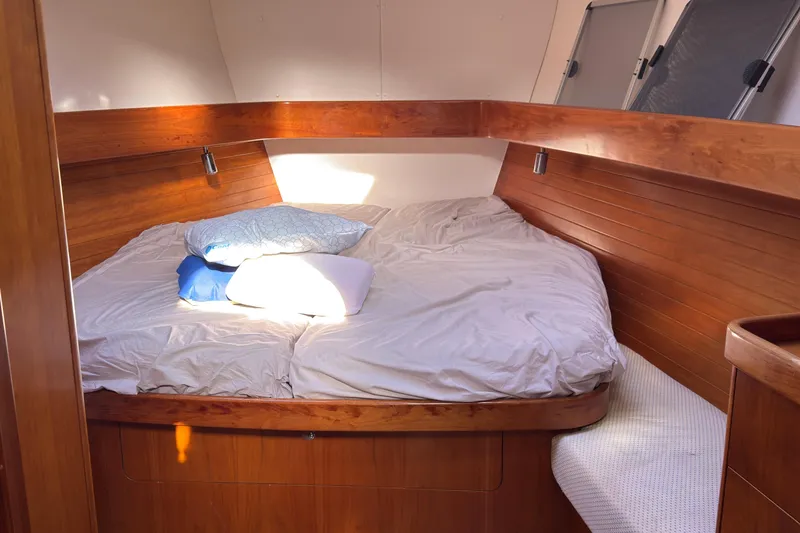 Slide: The Image of 2004 Alliaura FEELING 44 DI sailboat bow with anchor, docked in a residential canal. - 2