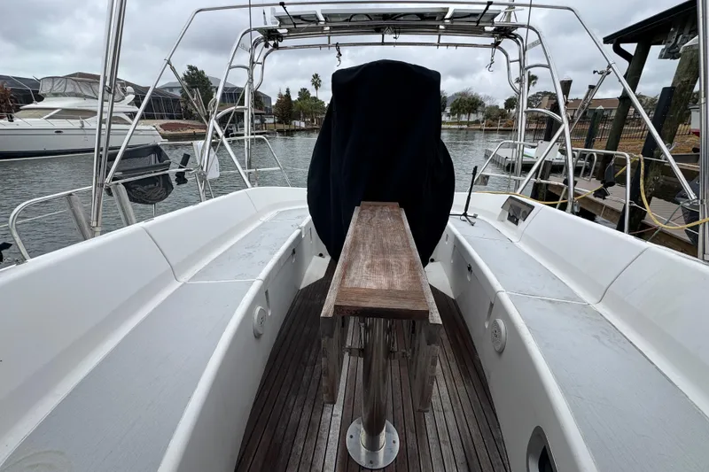 Slide: The Image of 2004 Alliaura FEELING 44 DI sailboat cockpit with wooden table, docked in marina. - 21