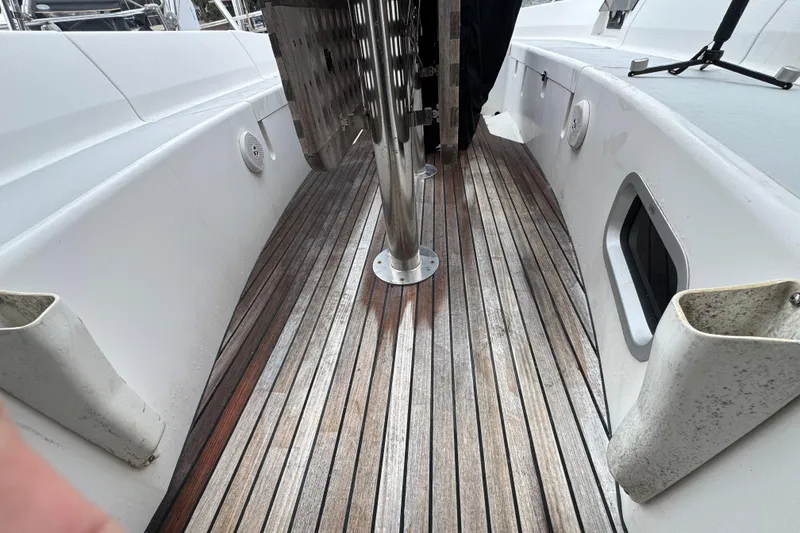 Slide: The Image of Deck of 2004 Alliaura FEELING 44 DI sailboat with wooden flooring and white railings. - 30