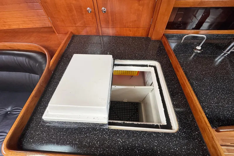 Slide: The Image of 2004 Alliaura FEELING 44 DI yacht interior with open storage compartment in kitchen area. - 48