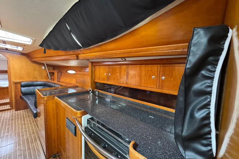 Slide: The Image of Luxurious 2004 Alliaura FEELING 44 DI yacht interior with sleek wood cabinetry and modern kitchen. - 51