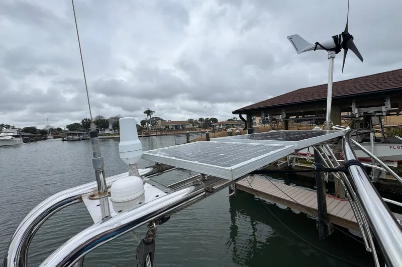 Slide: The Image of 2004 Alliaura FEELING 44 DI sailboat with solar panels and wind turbine at marina. - 8