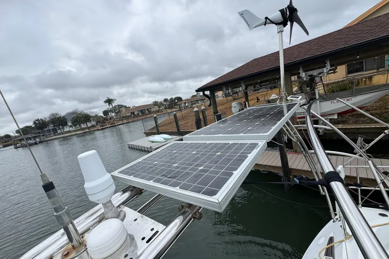 Slide: The Image of 2004 Alliaura FEELING 44 DI sailboat with solar panels and wind turbine at dock. - 9