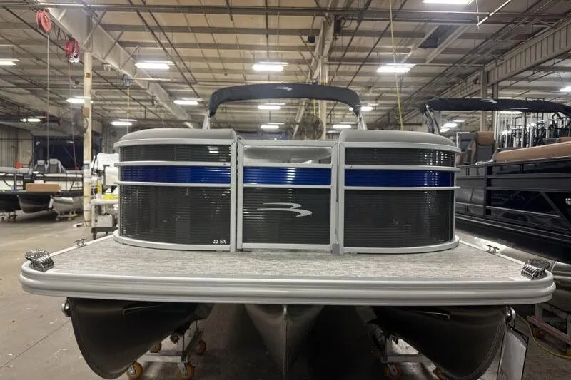 Slide: The Image of 2026 Bennington 22SXSR pontoon boat in a warehouse setting. - 3