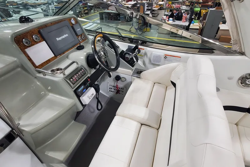 Slide: The Image of 2010 Formula 31 Performance Cruiser cockpit with white seating and advanced navigation controls. - 23