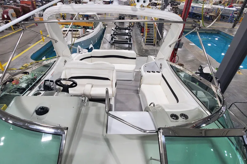 Slide: The Image of 2010 Formula 31 Performance Cruiser interior with white seating and steering wheel in a showroom. - 30