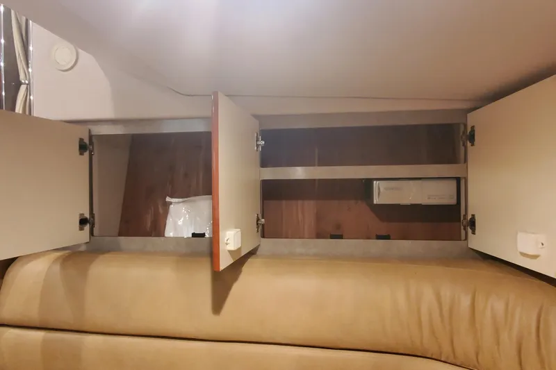 Slide: The Image of Open storage cabinets inside a 2010 Formula 31 Performance Cruiser boat interior. - 40