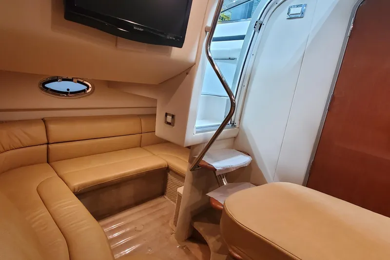 Slide: The Image of 2010 Formula 31 Performance Cruiser interior with beige seating and a mounted TV. - 47