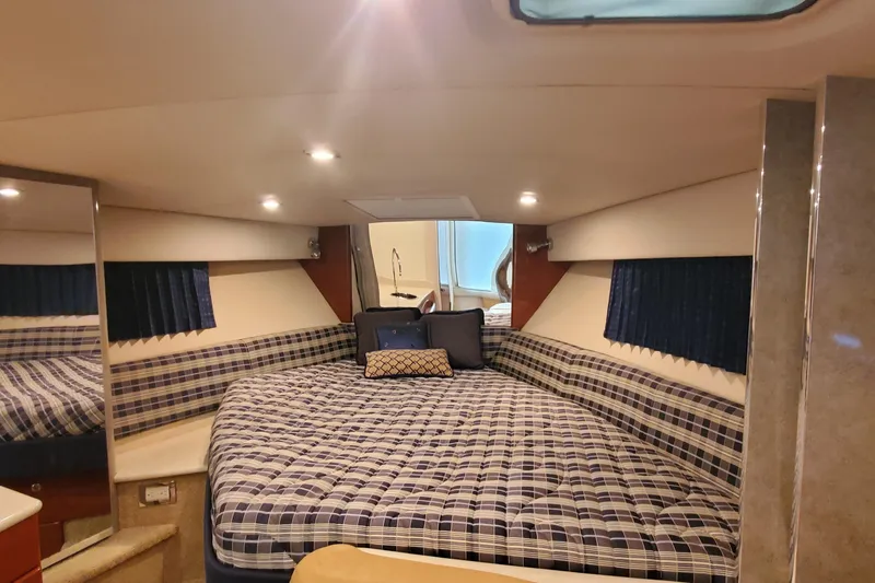 Slide: The Image of 2010 Formula 31 Performance Cruiser interior with plaid bedding and cozy lighting. - 48