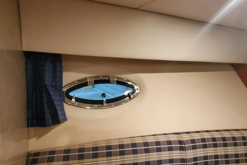 Slide: The Image of Interior of 2010 Formula 31 Performance Cruiser with porthole and plaid seating. - 49