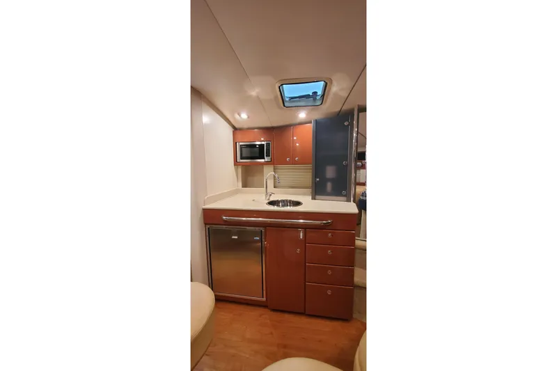 Slide: The Image of 2010 Formula 31 Performance Cruiser interior kitchen with modern amenities and wood cabinetry. - 54