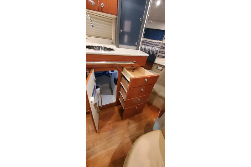 Slide: The Image of 2010 Formula 31 Performance Cruiser interior with open cabinets and drawers. - 60