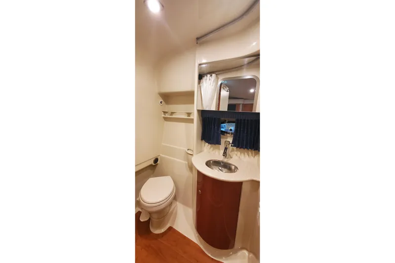 Slide: The Image of 2010 Formula 31 Performance Cruiser bathroom with toilet, sink, and mirror. - 65