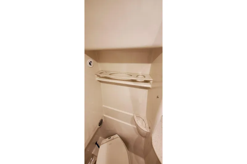 Slide: The Image of 2010 Formula 31 Performance Cruiser bathroom interior with toilet and shelf. - 66