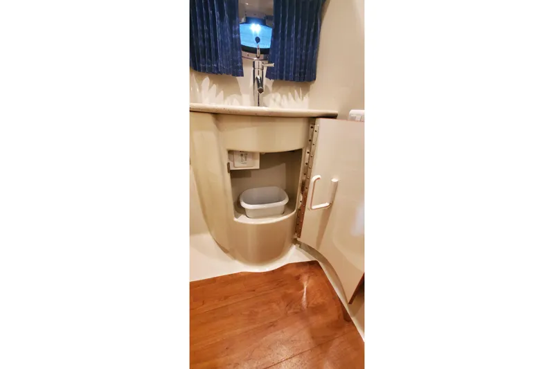 Slide: The Image of 2010 Formula 31 Performance Cruiser bathroom with sink, cabinet, and wooden flooring. - 68